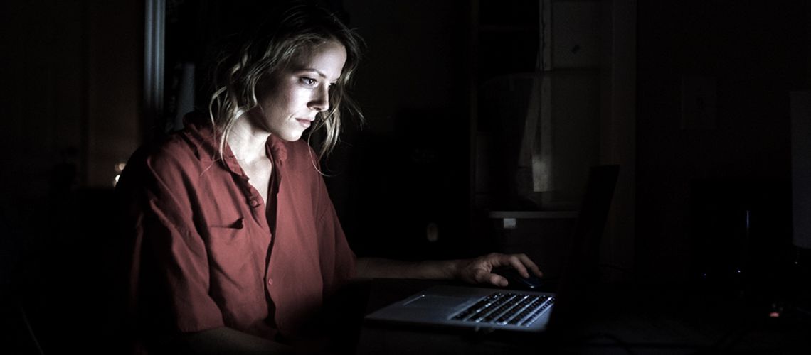 Exhausted woman working late at the computer.