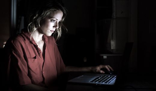 Exhausted woman working late at the computer.