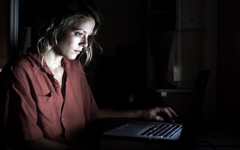 Exhausted woman working late at the computer.